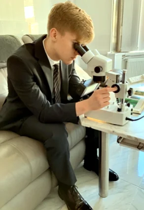 DGJV lab technician examining a stone under a microscope