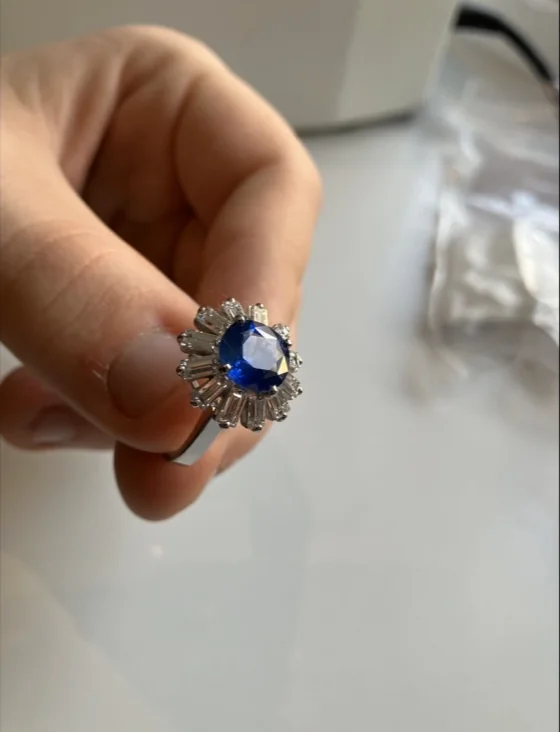 Blue sapphire and diamond ring in hand