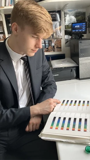 Lab technician reviewing colour grading chart