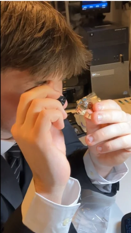 Lab technician examining a stone with a loupe